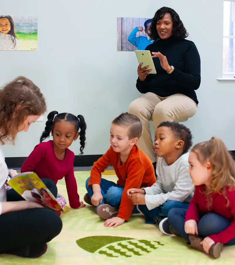 Teacher using a hand puppet to teach young children