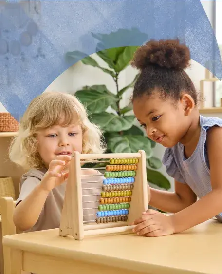 Two children using a wooden abicus