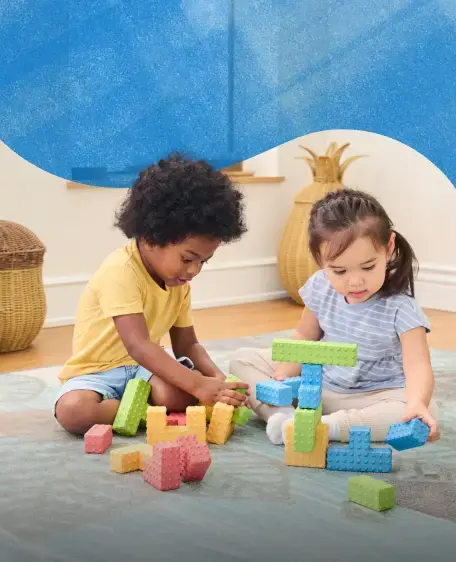 Two children playing with colorful blocks